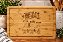 Load image into Gallery viewer, Front grooved side of bamboo cutting board with Kitchen Conversions engraving