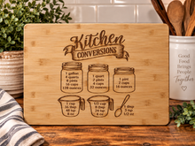 Load image into Gallery viewer, Bamboo cutting board with Kitchen Conversions engraving on the recommended flat back side
