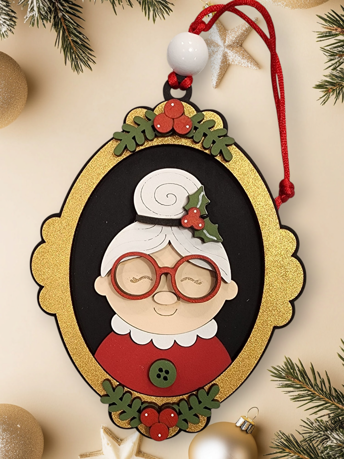 Layered wood Mrs. Claus Christmas ornament with holly, glasses, and festive red details