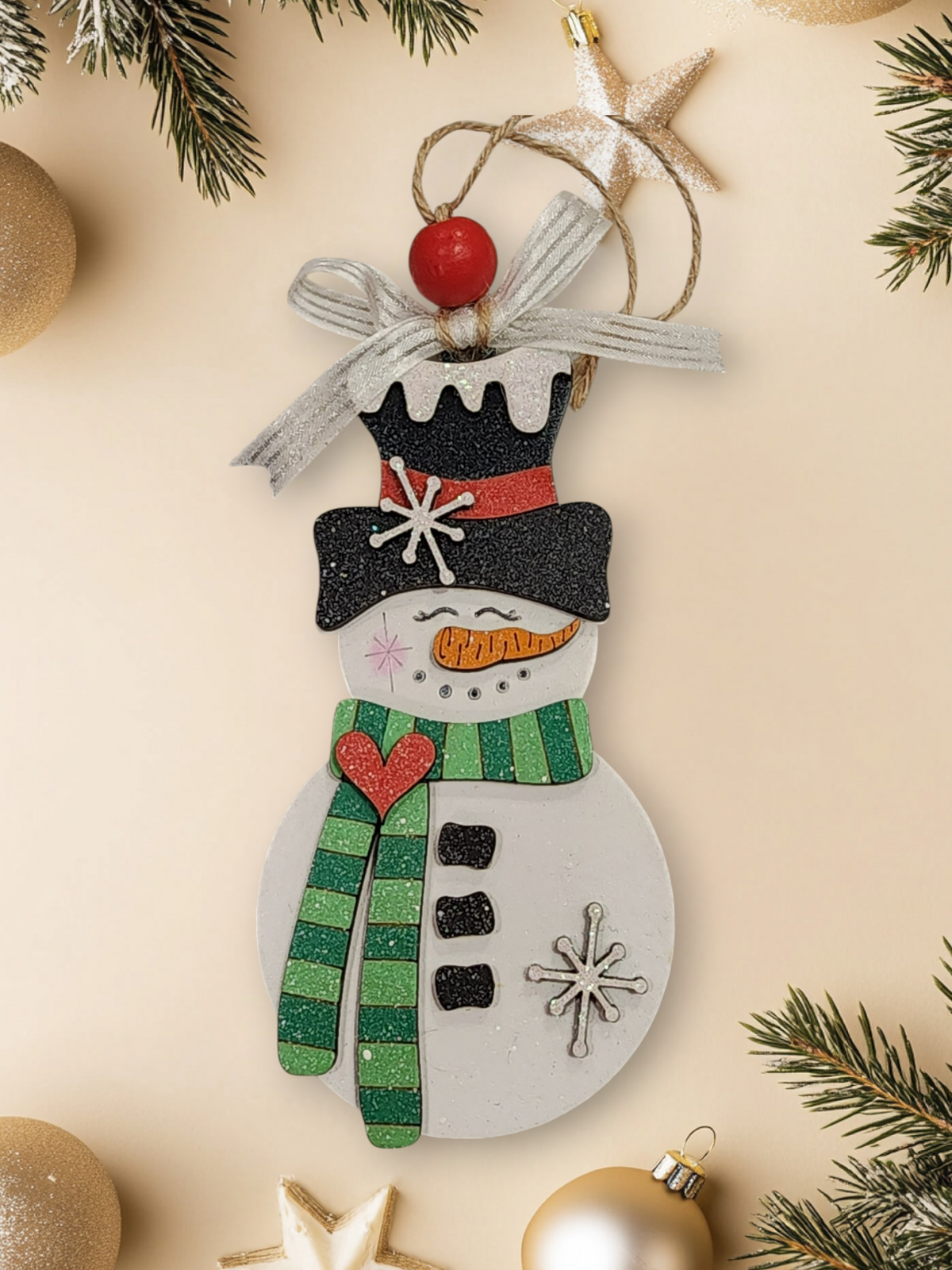 Whimsical layered wood snowman ornament with light and dark green striped scarf