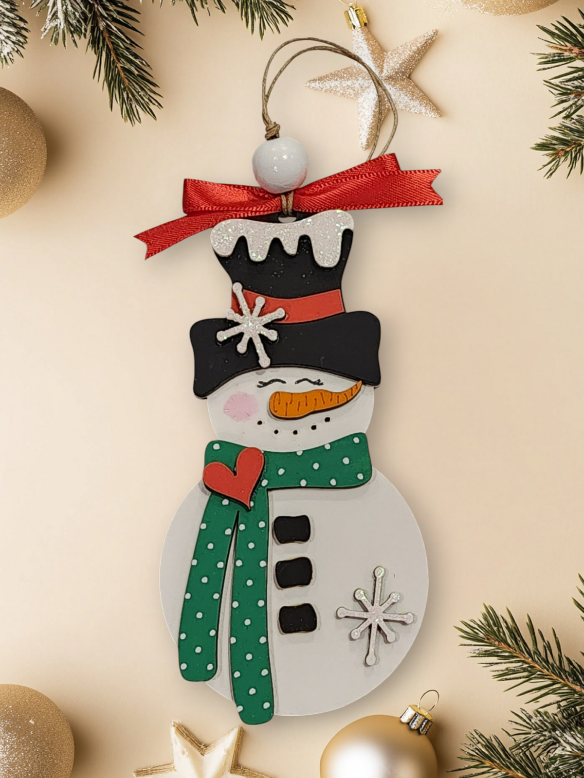 Whimsical layered wood snowman ornament with green polka dot scarf
